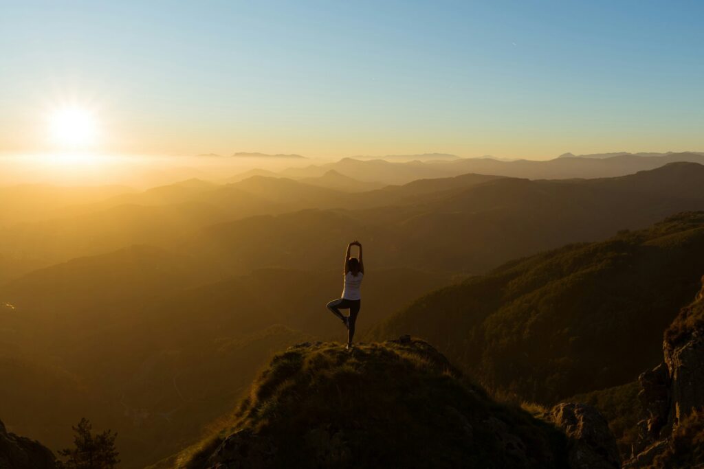 girl doing yoga on the mountain