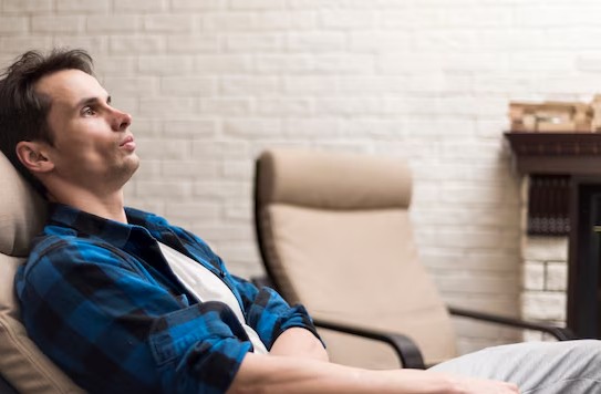 a relaxed man sitting in a chair