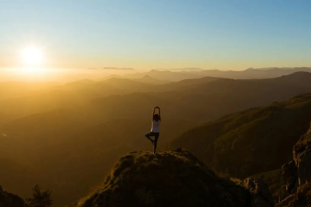 girl doing yoga on the mountain